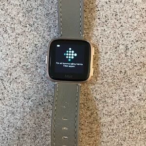 Fitbit Versa with small grey leather band